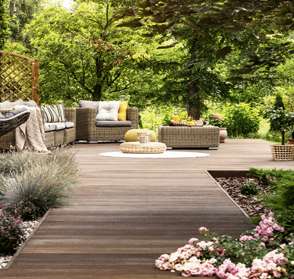 Elegant backyard with custom landscaping, outdoor furniture, and floral beds