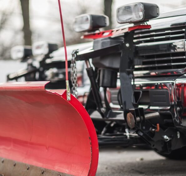 Close-up of red snow plow truck prepared for private estate snow removal